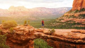 Travel in Devil's Bridge Trail, man Hiker with backpack enjoying view, Sedona, Arizona, USA